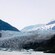 A few small ice floes floating at the base of Mendenhall Glacier